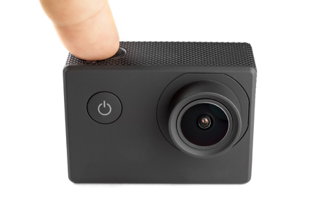 Action camera isolated on white background. Pushing the buttonの写真素材