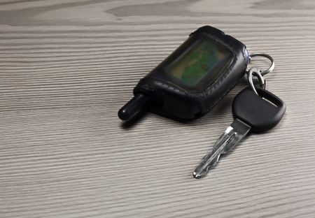 Car key with remote control on a wooden backgroundの写真素材