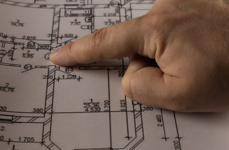Hand on plan of the houseの写真素材