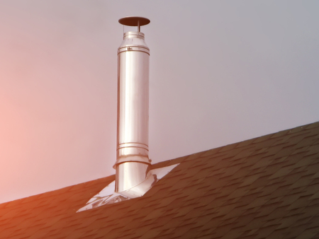 Chimney on tile roof. Red sky sunsetの写真素材