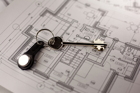 House keys on blueprint paper - properties and real estate conceptの写真素材