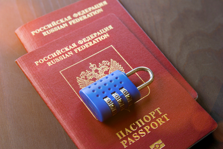 Two Russian Passports and lock on wood background. Tonedの写真素材