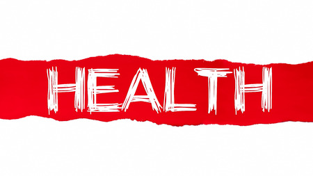 The word HEALTH appearing behind red torn paper.の写真素材
