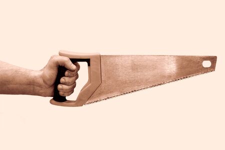 Male hand with yellow hacksaw isolated on white.の写真素材