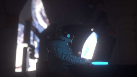 Astronaut works on his laptop in futuristic spaceship. 3d renderingの写真素材