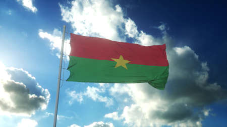 Flag of Burkina Faso waving at wind against beautiful blue sky. 3d illustrationの写真素材