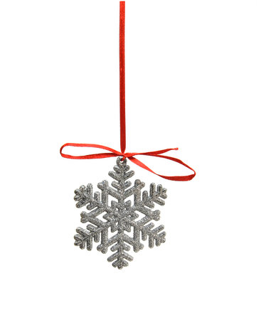 Christmas ornaments. Silver snowflake on a red ribbon. Photo on a white background.の写真素材