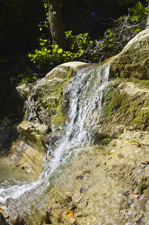 Waterfall in the forest. A small waterfall in autumn forest.の写真素材