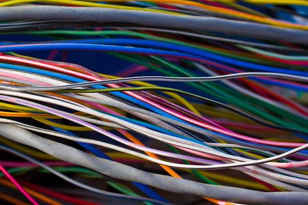 A jumble of multi colored wires from a carの写真素材