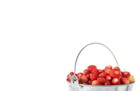 Small bucket full of strawberries isolated on white backgroundの写真素材