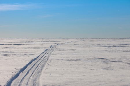 Snow  desert. Snowy path to the horizonの写真素材