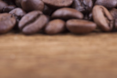 coffee grains on grunge wooden background closeupの写真素材
