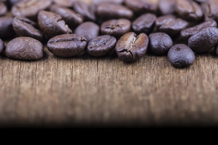 coffee grains on grunge wooden background close upの写真素材