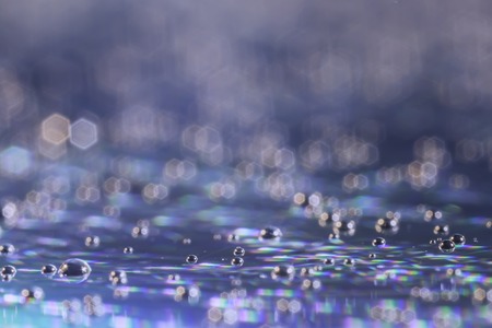 Abstract blurred rainbow water drops close up