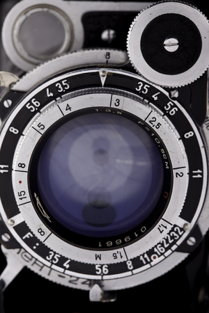 the old lens vintage camera looks at you, close upの写真素材