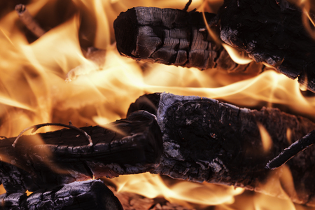 red hot flame coals firewood close upの写真素材