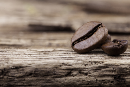 grains of coffee on rough wooden surface close upの写真素材