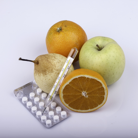 lot of fruits, pills and thermometer on white background closeupの写真素材