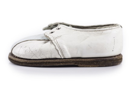 children's old shoe closeup on a white backgroundの写真素材