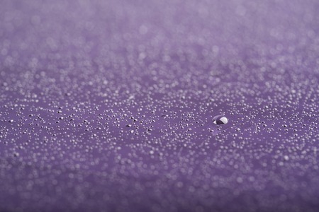 macro purple drops on glass close up abstract backgroundの写真素材