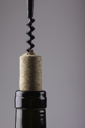 neck of a wine bottle cork and corkscrew closeupの写真素材