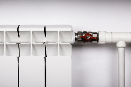 White radiator in an apartment faucet valve closeupの写真素材