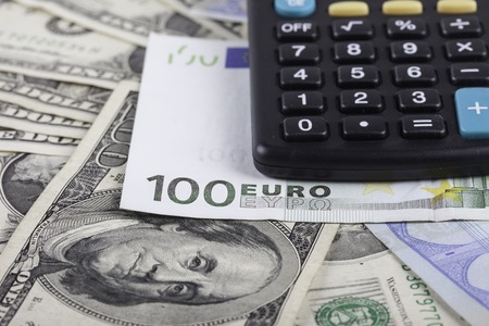 calculator and banknotes of dollars and euro close upの写真素材