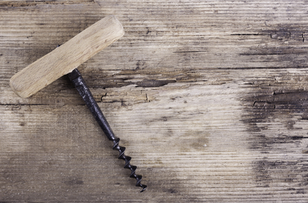 old corkscrew on the background of wood backgroundの写真素材