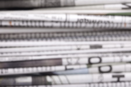 defocused stack of old Newspapers blurred backgroundの写真素材