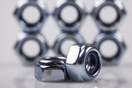 metal nuts close up on white backgroundの写真素材