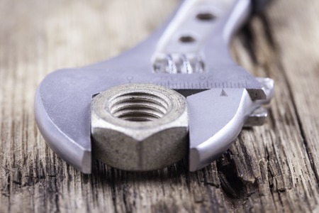 wrench close up on wood surface backgroundの写真素材