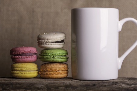 Side view the cup of coffee and cakes on wooden backgroundの写真素材