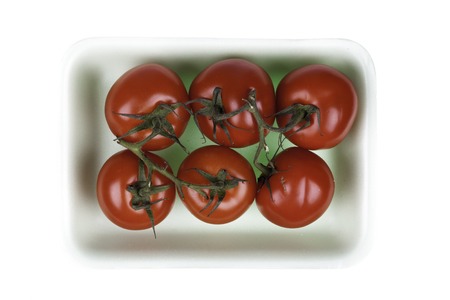 tomatoes closup in the package isolated on whiteの写真素材