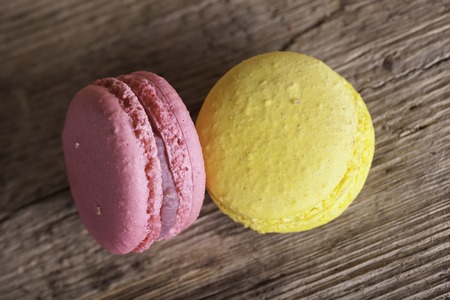 Colorful French macaroons closeup on a dark  wooden background, selective focusの写真素材