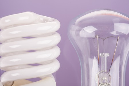 two types of light bulbs closeup on blue background