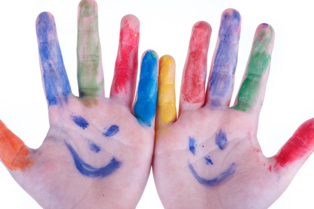 childrens hands closeup painted colors  isolated on white backgroundの写真素材