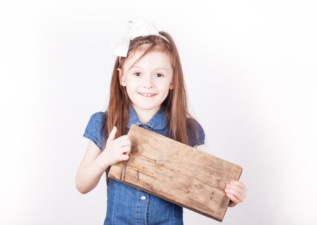 child girl with board for inscription in hands on white background