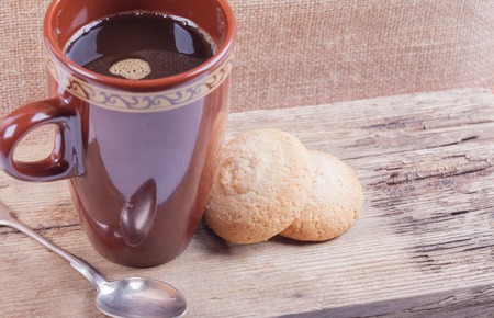 cookies  and cup of coffee brown plat still lifeの写真素材