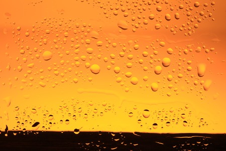 abstract yellow background with water drops closeupの写真素材