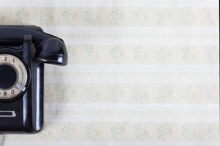 vintage phone on the wall with rerto wall paperの写真素材