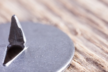 extra macro image of a metal pushpin on woodの写真素材
