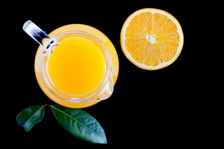 pitcher of fresh orange juice on a black background top viewの写真素材