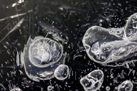 abstraction. bubbles inside fresh ice macro closeupの写真素材