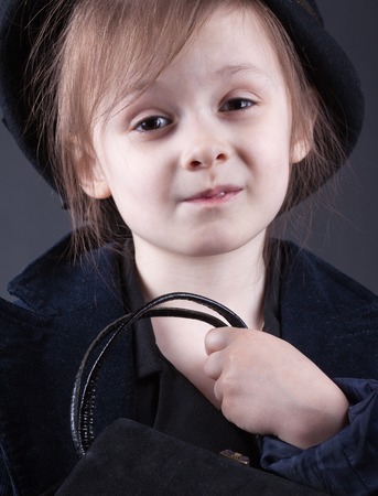 portrait of pretty retro dressed child girl.  studio photo on a  black backgroundの写真素材