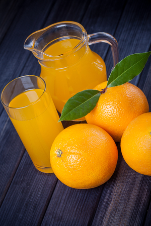 orange juice in the jug on the table close upの写真素材