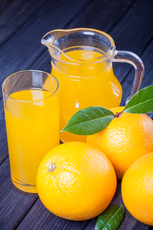orange juice in the jug on the table close upの写真素材