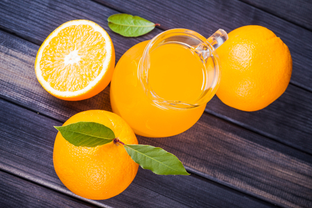 orange juice in the jug on the table close upの写真素材