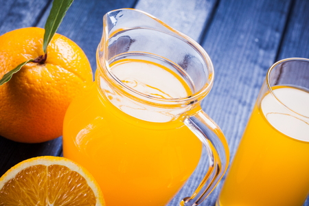 orange juice in the jug on the tableの写真素材