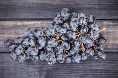 bunch of black grapes close up on the table still lifeの写真素材
