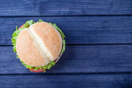 Burger on wooden table top view copy spaceの写真素材